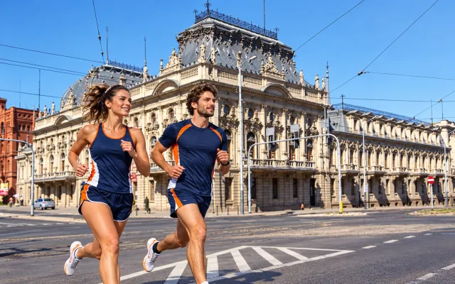 Running illustration for Łódź: adult runners in a destination setting; not the featured race edition or its course.