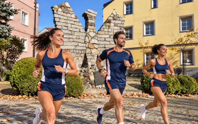Running illustration for Ustrzyki Dolne: adult runners in a destination setting; not the featured race edition or its course.